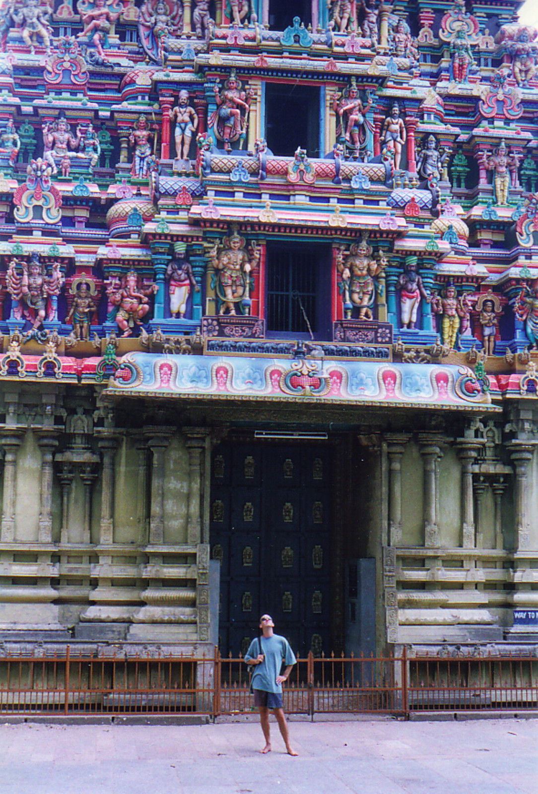 Howard standing beneath a large gopuram in Madurai