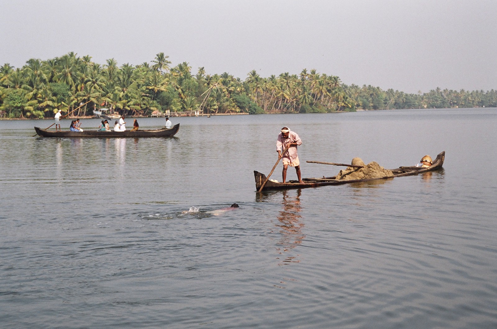 Men filling a canoe filled with sand