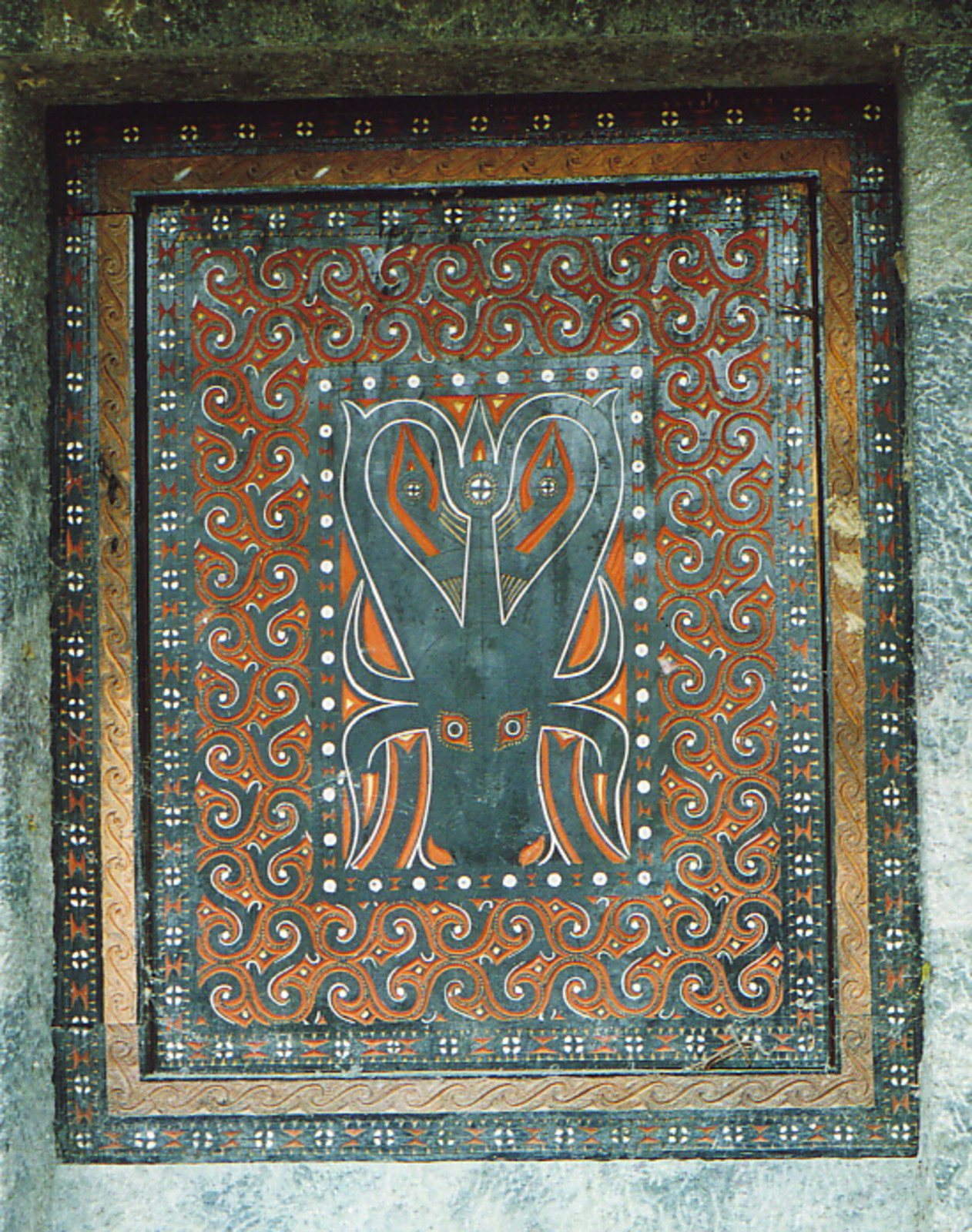 A water buffalo on the door to a Torajan grave